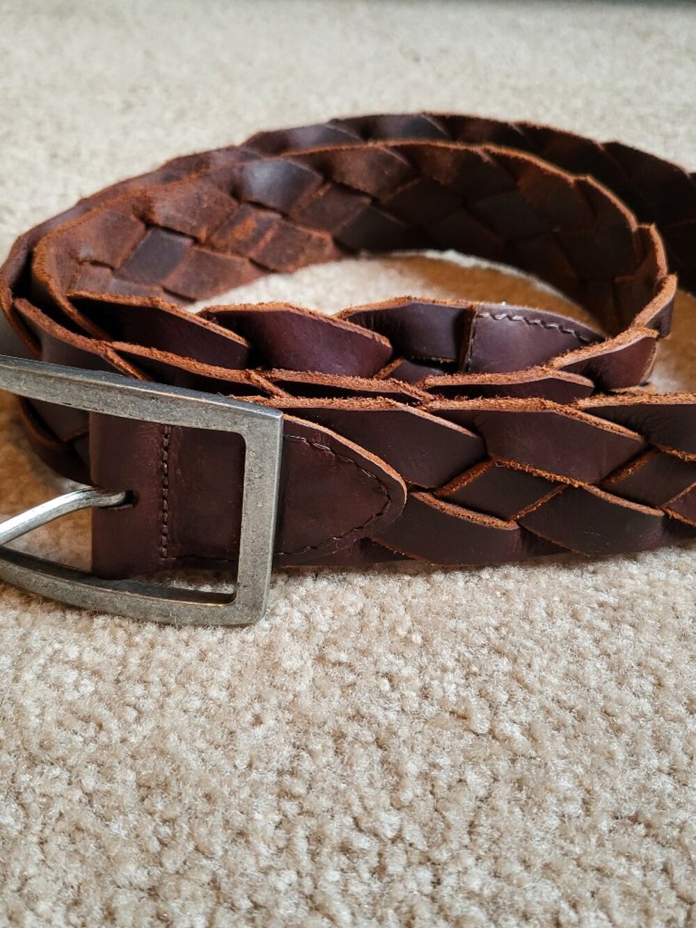 Braided brown leather belt with silver tone buckle